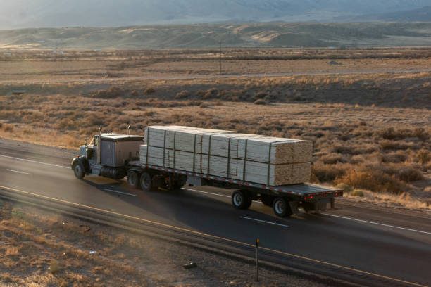 Long Haul Semi Truck on a Highway at Dusk under a Dramatic Sky